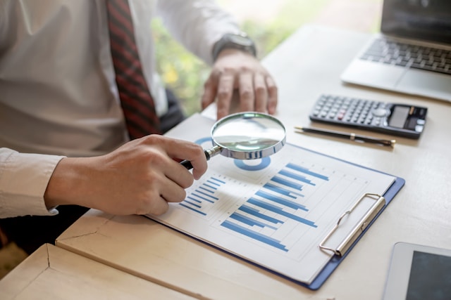 a forensic fraud examiner looking over financials