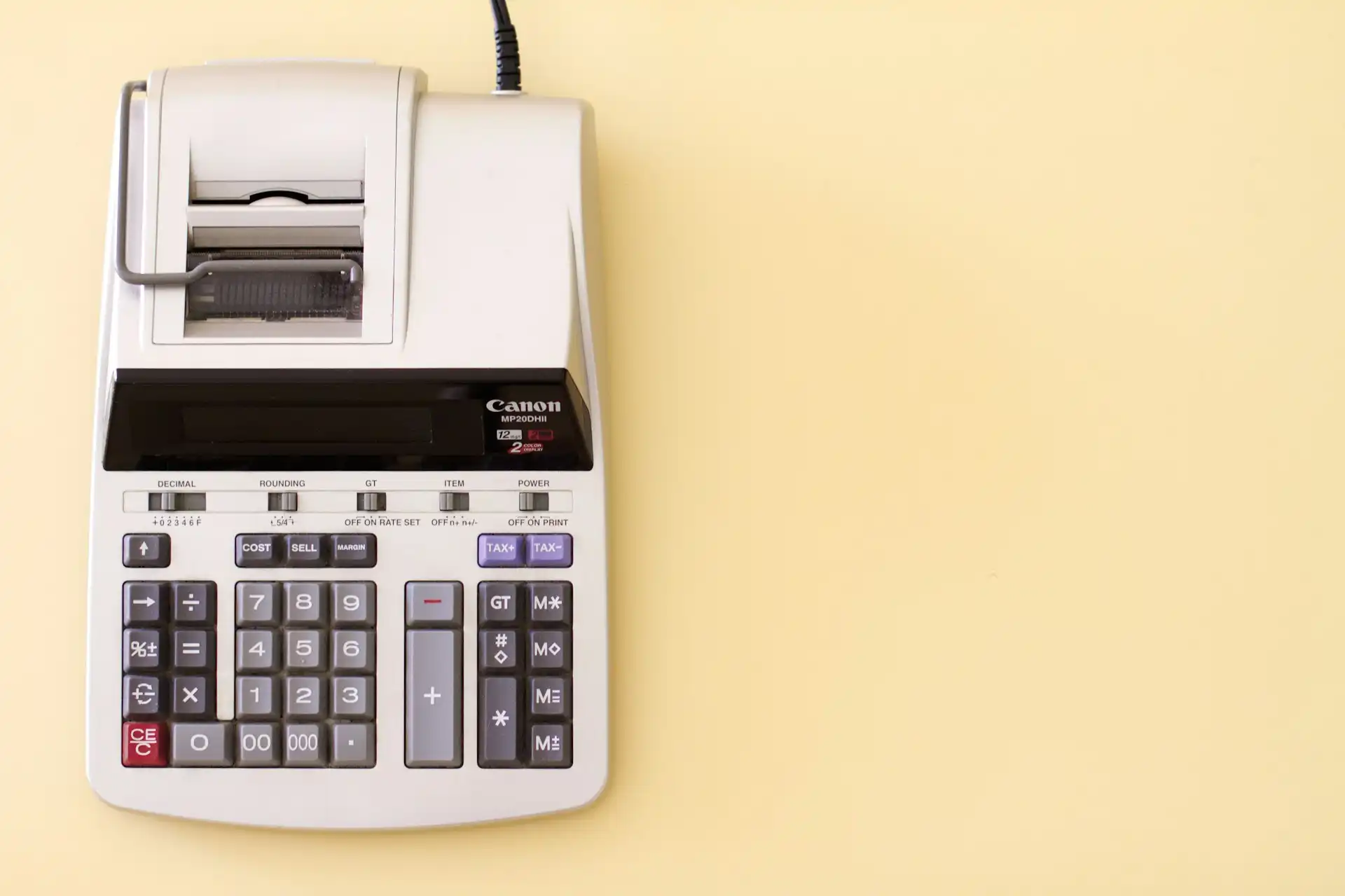 A ten-key accounting calculator on a yellow background